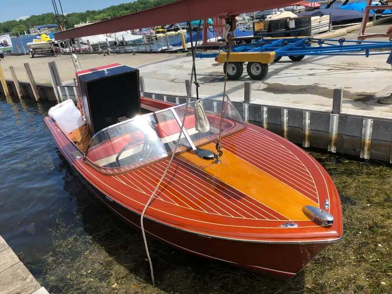 Slide: The Image of 1959 Chris-Craft 18 Continental wooden boat docked at a marina. - 5