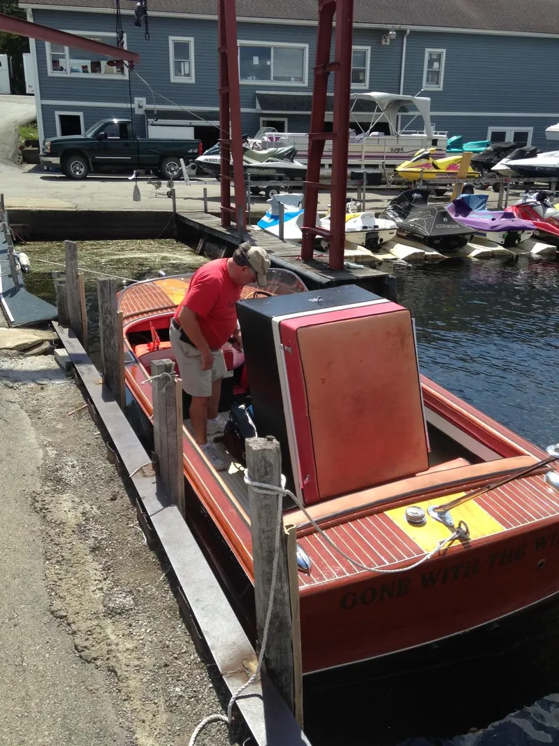 Slide: The Image of 1959 Chris-Craft 18 Continental boat docked at a marina with a person onboard. - 7