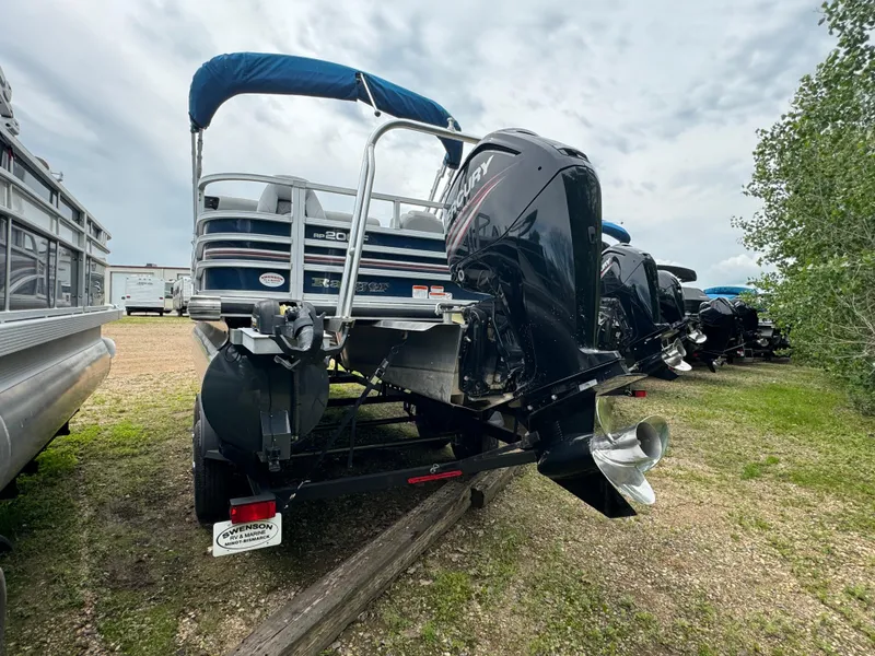 Slide: The Image of 2019 Ranger Reata 200F pontoon boat with outboard motor, parked on a trailer. - 5