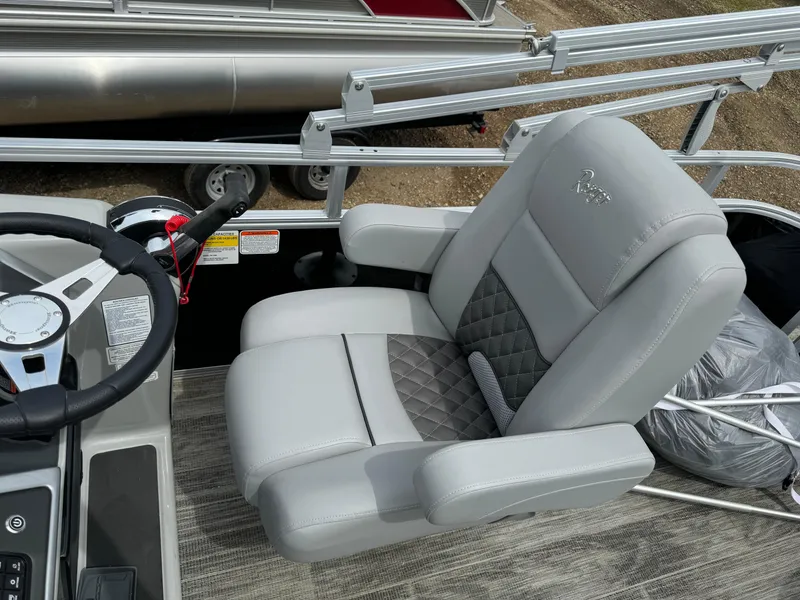 Slide: The Image of 2024 Ranger Reata 220C boat captain's chair and steering console. - 14