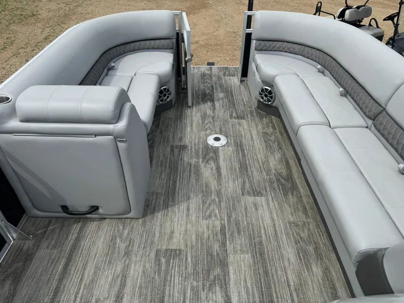 Slide: The Image of 2024 Ranger Reata 220C pontoon boat interior with gray seating and flooring. - 16