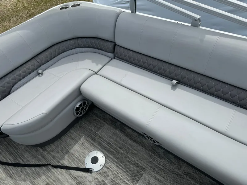 Slide: The Image of 2024 Ranger Reata 220C boat interior with gray cushioned seating and modern design. - 18