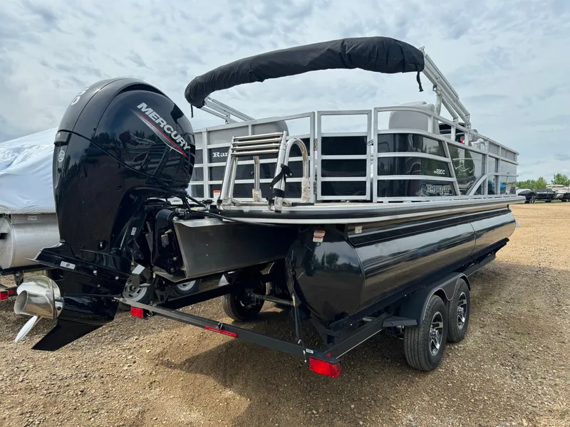 Slide: The Image of 2024 Ranger Reata 220C pontoon boat with Mercury outboard engine on trailer. - 3