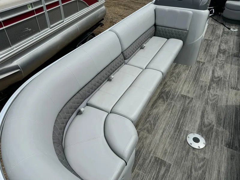 Slide: The Image of 2024 Ranger Reata 220C pontoon boat with luxurious gray seating and wood-patterned flooring. - 7