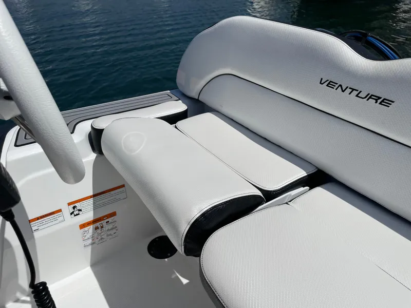 Slide: The Image of Walker Bay Venture 13 2025 boat interior with white cushioned seating. - 12