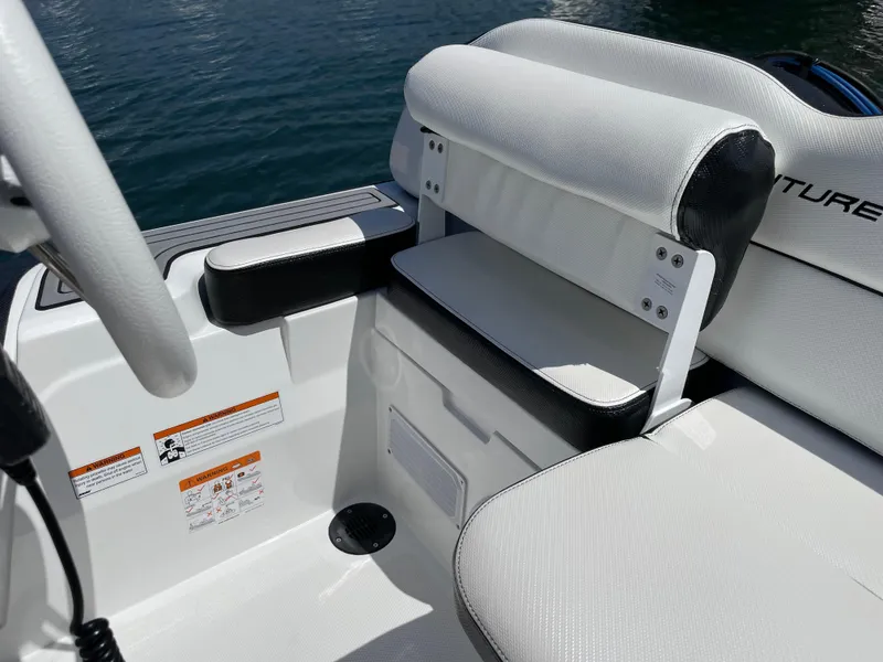 Slide: The Image of 2025 Walker Bay Venture 13 boat interior seating and console. - 13