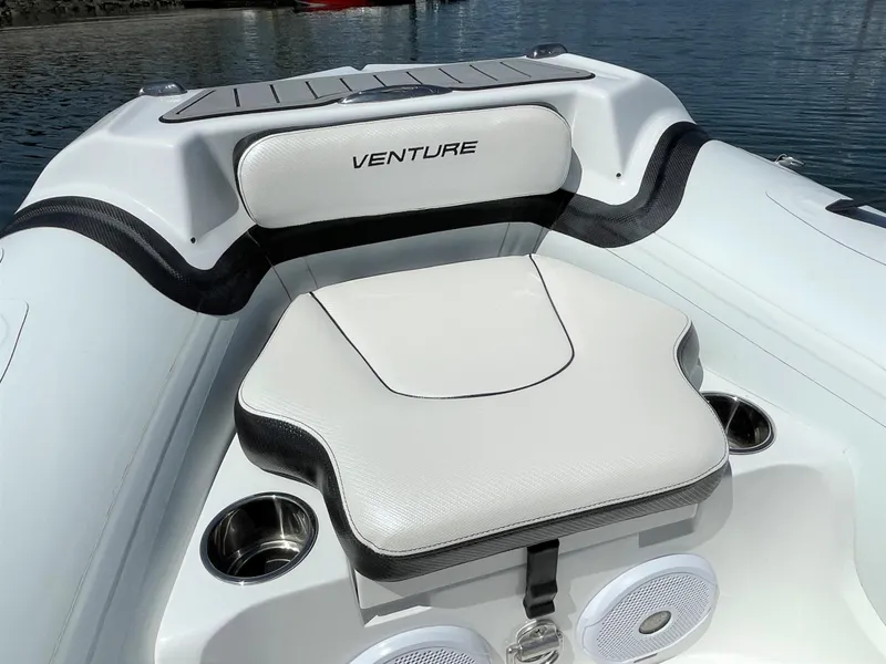 Slide: The Image of Walker Bay Venture 13 (2025) boat interior with cushioned seating and cup holders. - 4