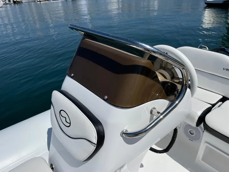 Slide: The Image of 2025 Walker Bay Venture 13 boat console with windshield and steering wheel. - 8