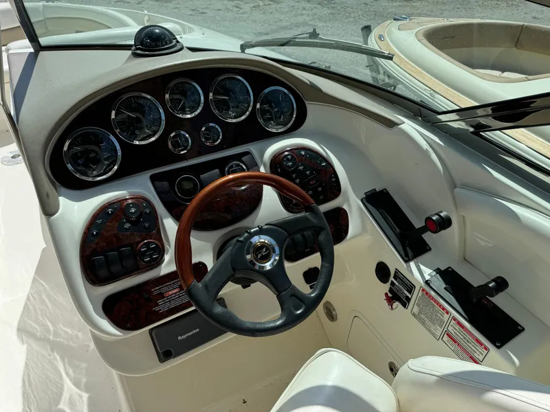 Slide: The Image of 2002 Sea Ray 290 Bow Rider dashboard with steering wheel and instrument panel. - 11