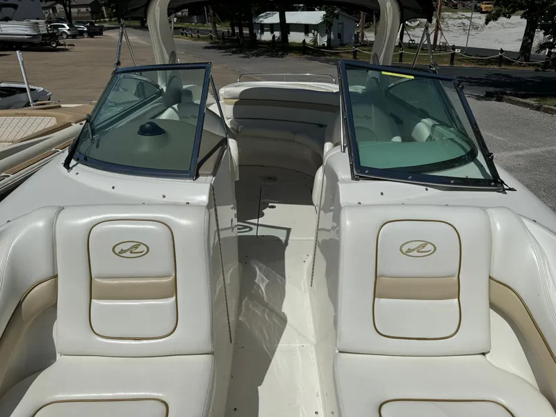 Slide: The Image of 2002 Sea Ray 290 Bow Rider boat interior with dual windshields and seating. - 13