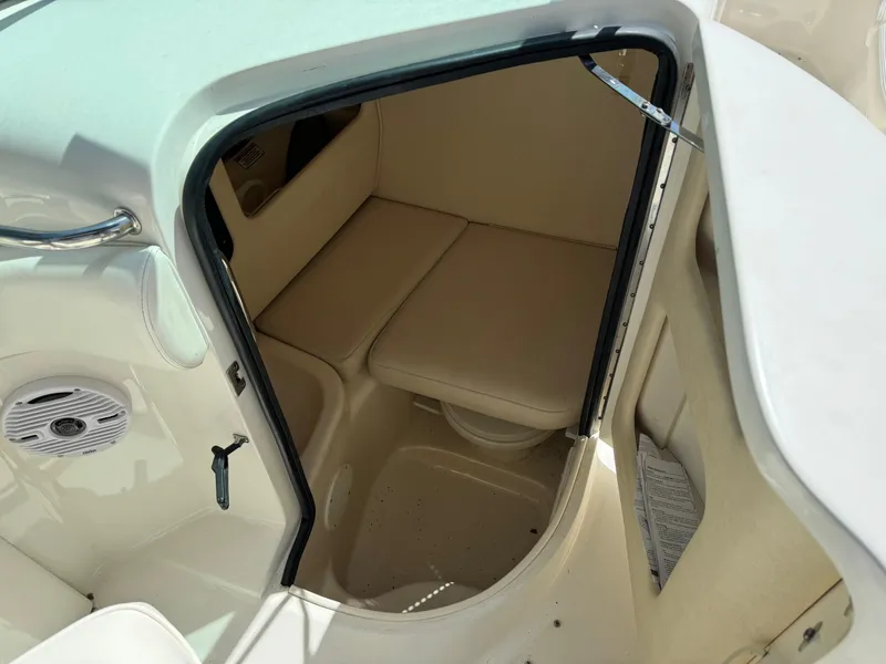Slide: The Image of 2002 Sea Ray 290 Bow Rider cabin interior with beige seating. - 14
