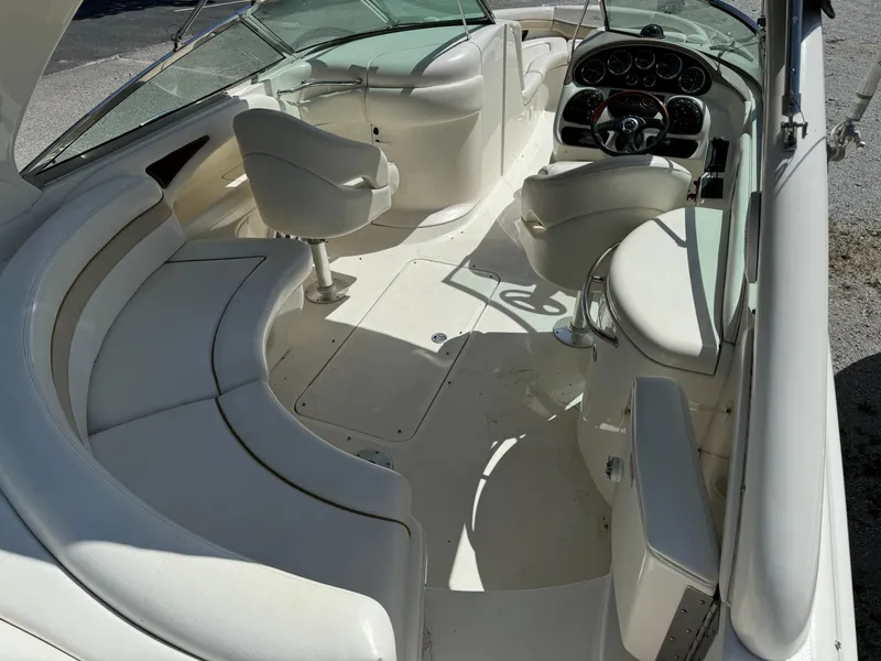 Slide: The Image of 2002 Sea Ray 290 Bow Rider interior with white seating and dashboard. - 6