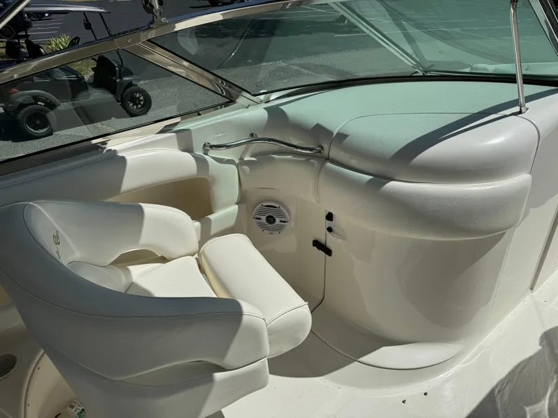 Slide: The Image of 2002 Sea Ray 290 Bow Rider cockpit with white seating and dashboard. - 8