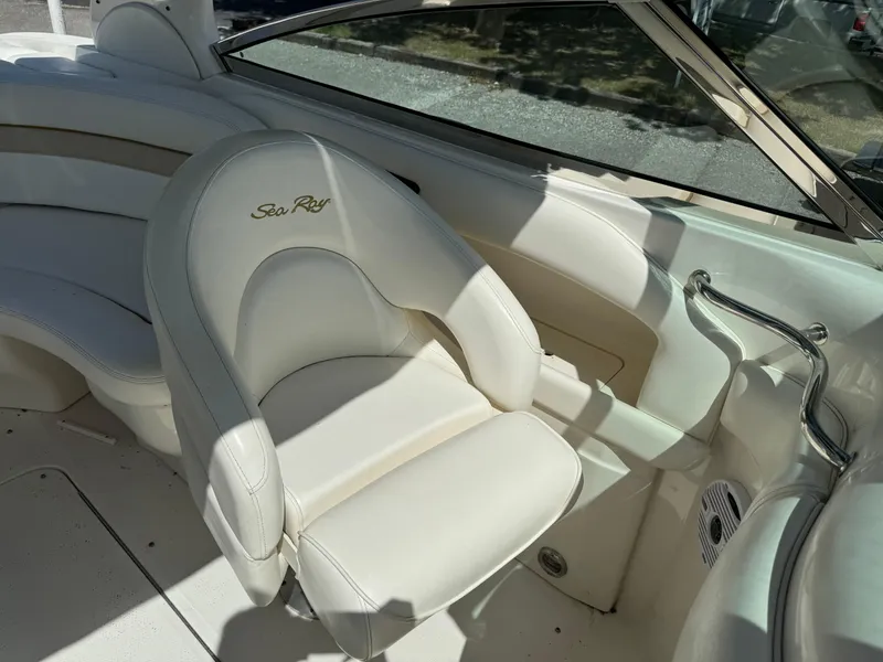 Slide: The Image of 2002 Sea Ray 290 Bow Rider boat interior with white seating. - 9