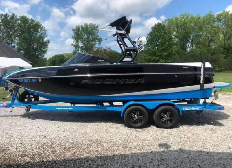 Slide: The Image of 2019 Moomba Craz boat on a blue trailer, parked outdoors. - 3