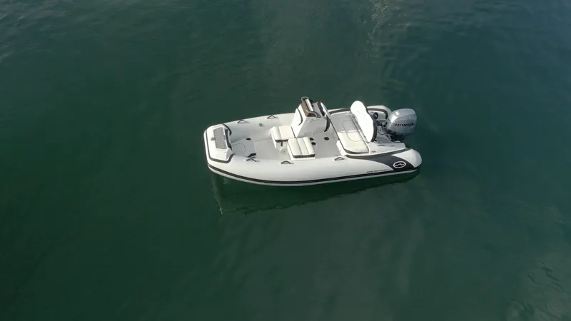 Slide: The Image of 2025 Walker Bay Generation 13 LTE boat on calm water. - 3