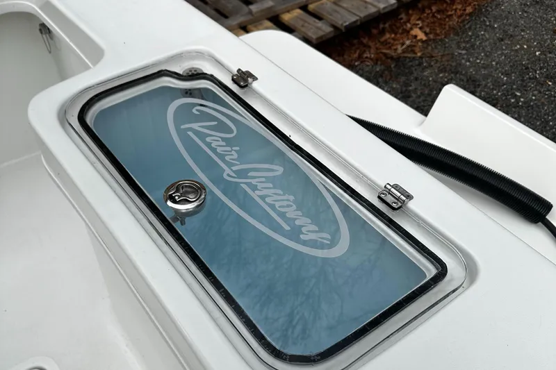 Slide: The Image of 2024 Pair Customs 21DV boat compartment with logo on glass lid. - 4