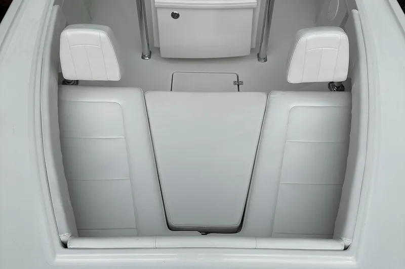 Slide: The Image of 2024 Pair Customs 21DV boat interior with white leather seating and storage compartments. - 7