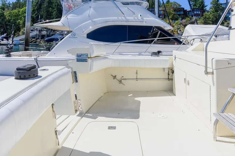 Slide: The Image of 1987 Hatteras 72 Flush Deck Cockpit Motor Yacht, spacious deck, marina background. - 15