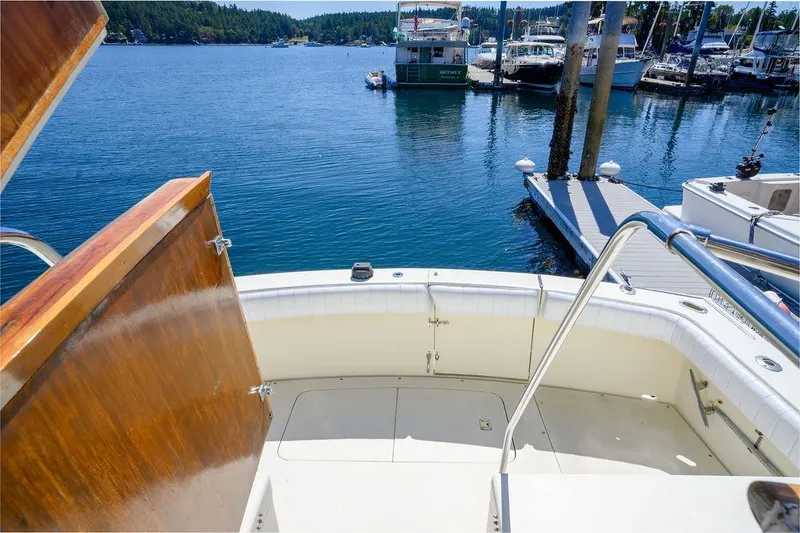 Slide: The Image of 1987 Hatteras 72 Flush Deck Cockpit Motor Yacht at marina, sunny day, calm water. - 18