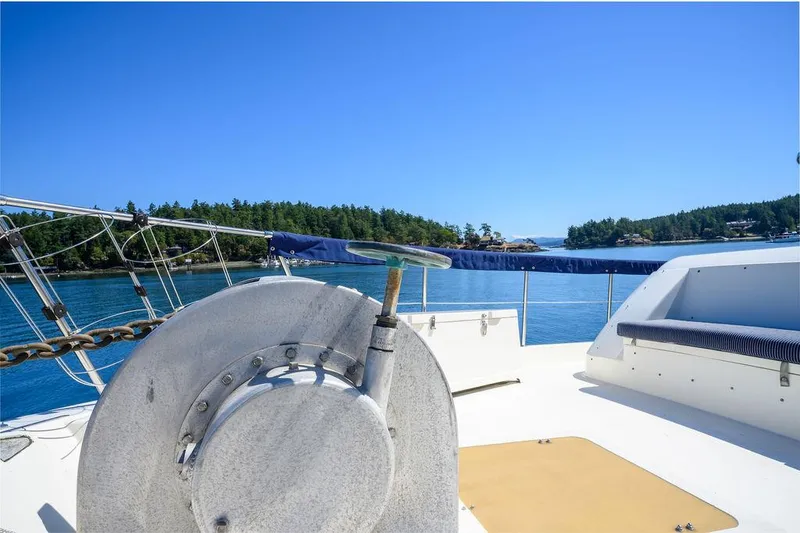 Slide: The Image of 1987 Hatteras 72 Flush Deck Cockpit Motor Yacht on serene blue waters. - 22