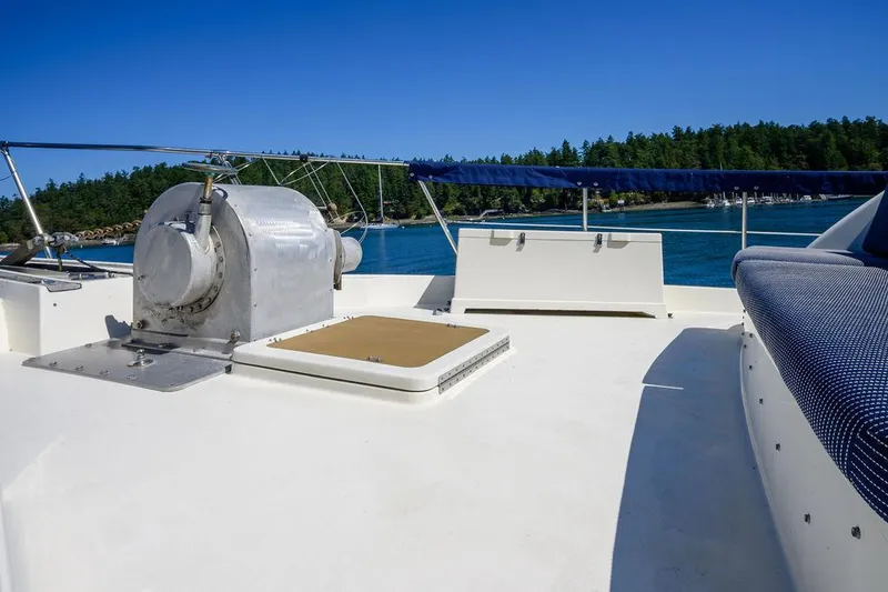 Slide: The Image of 1987 Hatteras 72 Flush Deck Cockpit Motor Yacht deck with scenic water view. - 24