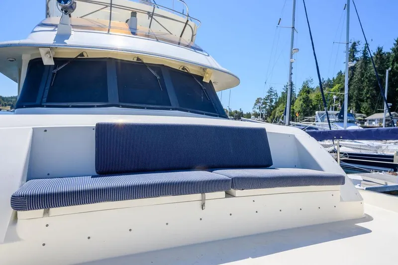 Slide: The Image of 1987 Hatteras 72 Flush Deck Cockpit Motor Yacht with striped seating on deck. - 26