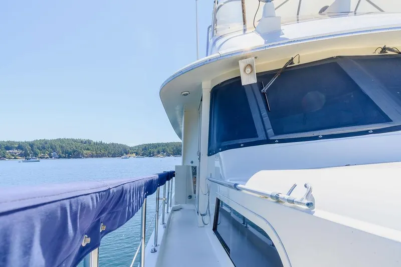 Slide: The Image of 1987 Hatteras 72 Flush Deck Cockpit Motor Yacht on serene water. - 29