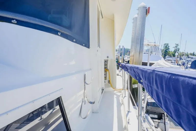 Slide: The Image of 1987 Hatteras 72 Flush Deck Cockpit Motor Yacht docked at marina. - 30