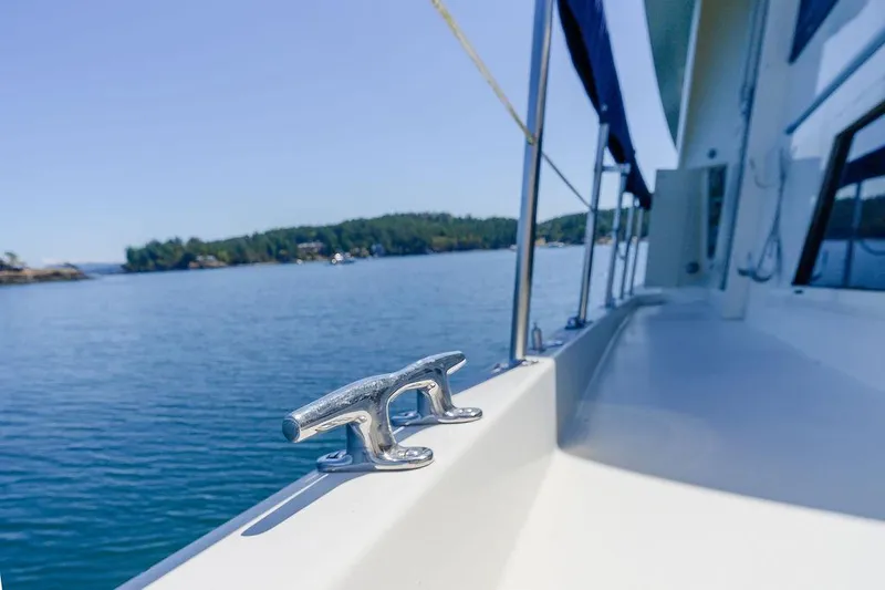Slide: The Image of 1987 Hatteras 72 Flush Deck Cockpit Motor Yacht on calm water, sunny day. - 32