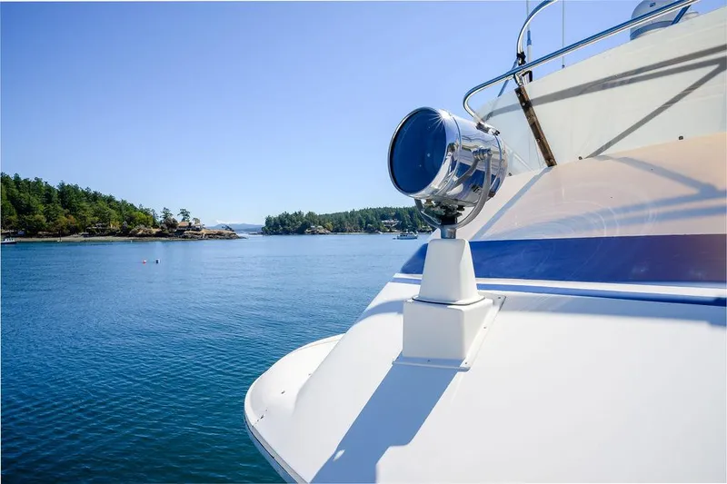 Slide: The Image of 1987 Hatteras 72 Flush Deck Cockpit Motor Yacht on serene blue waters. - 35