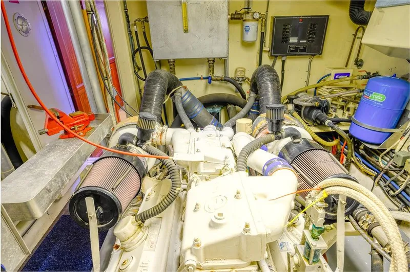 Slide: The Image of Engine room of 1987 Hatteras 72 Flush Deck Cockpit Motor Yacht, showcasing mechanical components. - 37