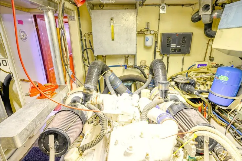Slide: The Image of Engine room of 1987 Hatteras 72 Flush Deck Cockpit Motor Yacht, showcasing mechanical components. - 38