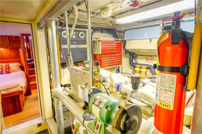 Slide: The Image of Engine room of 1987 Hatteras 72 Flush Deck Cockpit Motor Yacht with tools and fire extinguisher. - 39