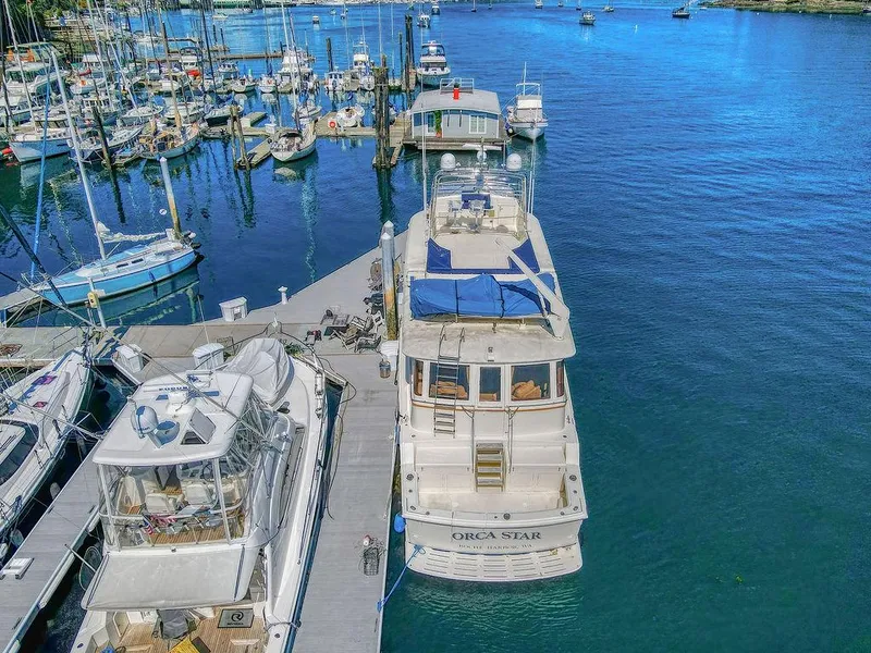 Slide: The Image of 1987 Hatteras 72 Flush Deck Cockpit Motor Yacht docked in a marina. - 4