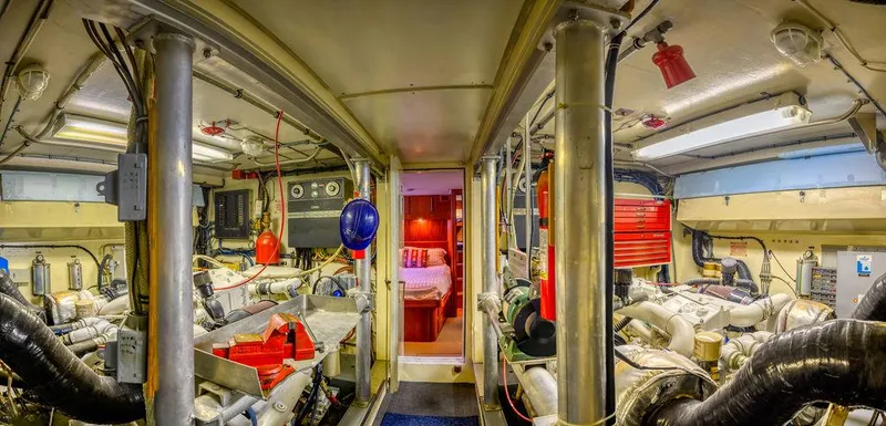 Slide: The Image of Engine room of 1987 Hatteras 72 Flush Deck Cockpit Motor Yacht, featuring mechanical equipment. - 40