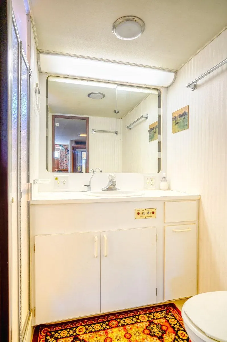 Slide: The Image of Bathroom interior of 1987 Hatteras 72 Flush Deck Cockpit Motor Yacht, featuring vanity and mirror. - 48
