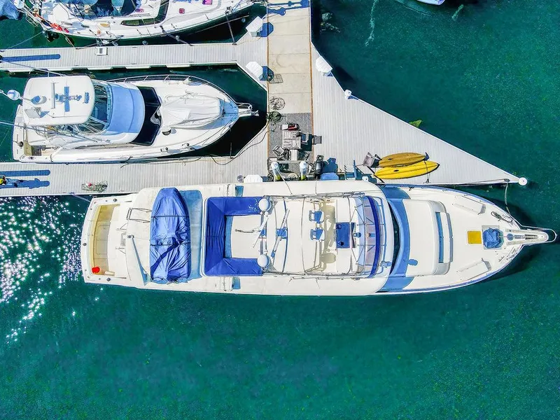 Slide: The Image of Aerial view of 1987 Hatteras 72 Flush Deck Cockpit Motor Yacht docked in marina. - 5