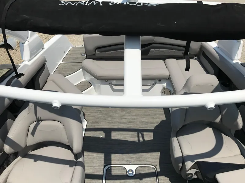 Slide: The Image of 2025 Four Winns HD3 boat interior with beige seating and modern design. - 10