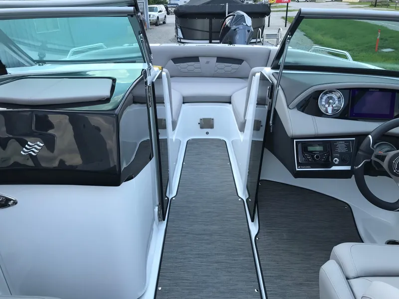 Slide: The Image of 2025 Four Winns HD3 boat interior with modern dashboard and seating area. - 4