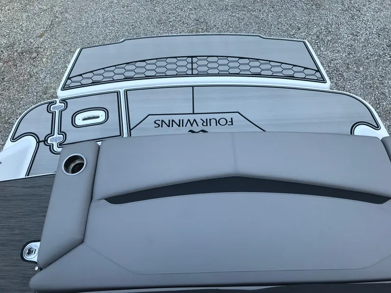 Slide: The Image of 2025 Four Winns HD3 boat deck with gray seating and logo. - 7