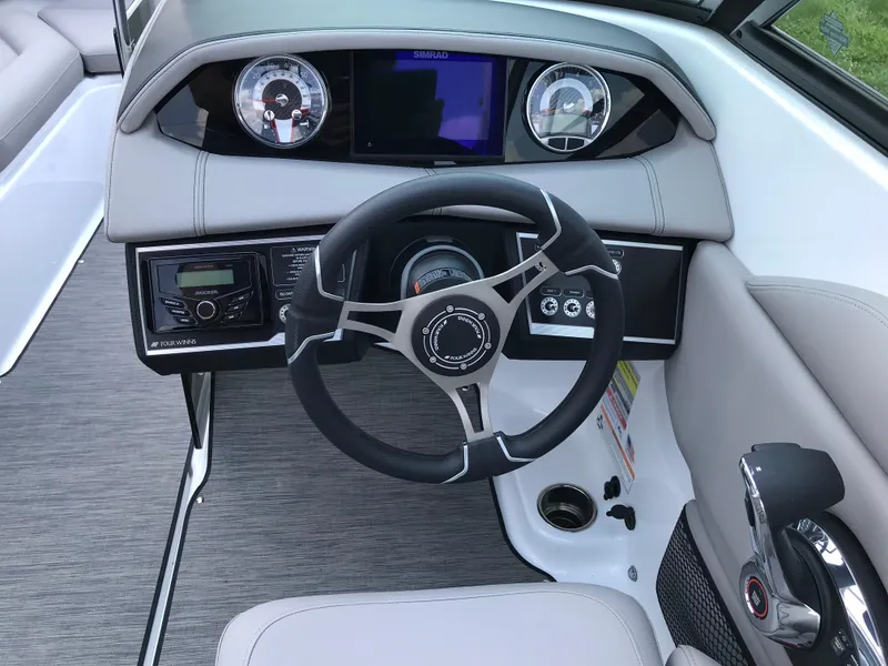 Slide: The Image of 2025 Four Winns HD3 boat dashboard with steering wheel and control panel. - 8