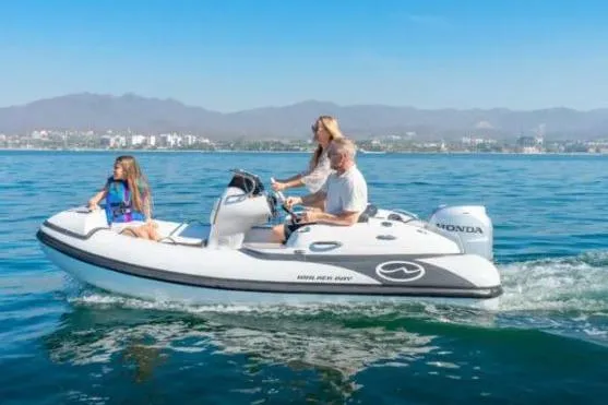 Slide: The Image of Walker Bay Generation 12 boat cruising on water, 2025 model, with passengers enjoying the ride. - 6