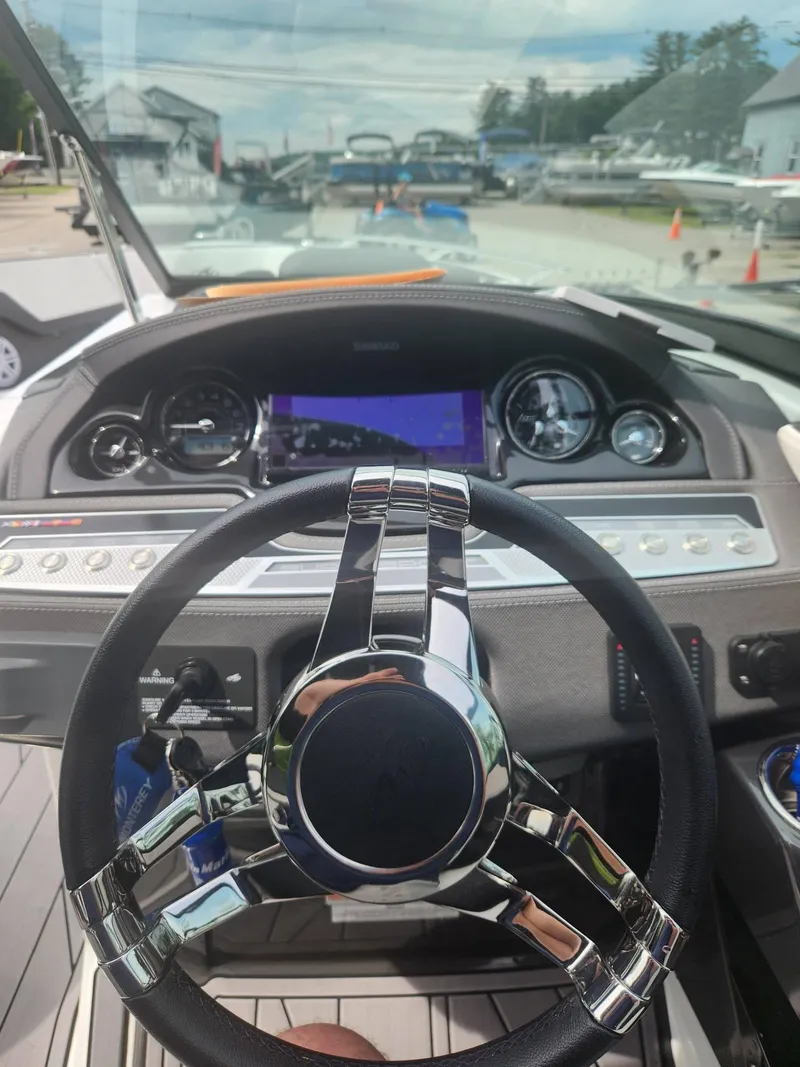 Slide: The Image of 2022 Monterey 278SS boat dashboard with steering wheel and navigation display. - 15