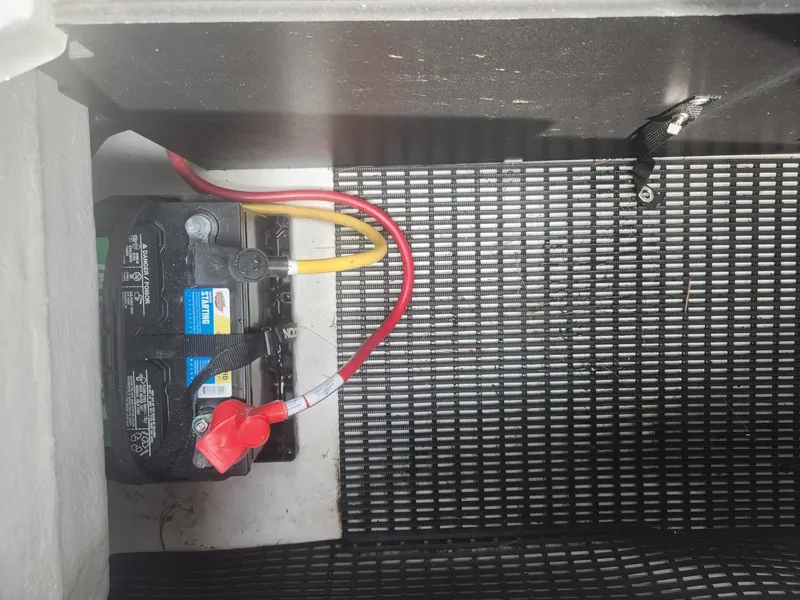 Slide: The Image of Battery compartment of a 2022 Monterey 278SS boat with connected cables. - 17