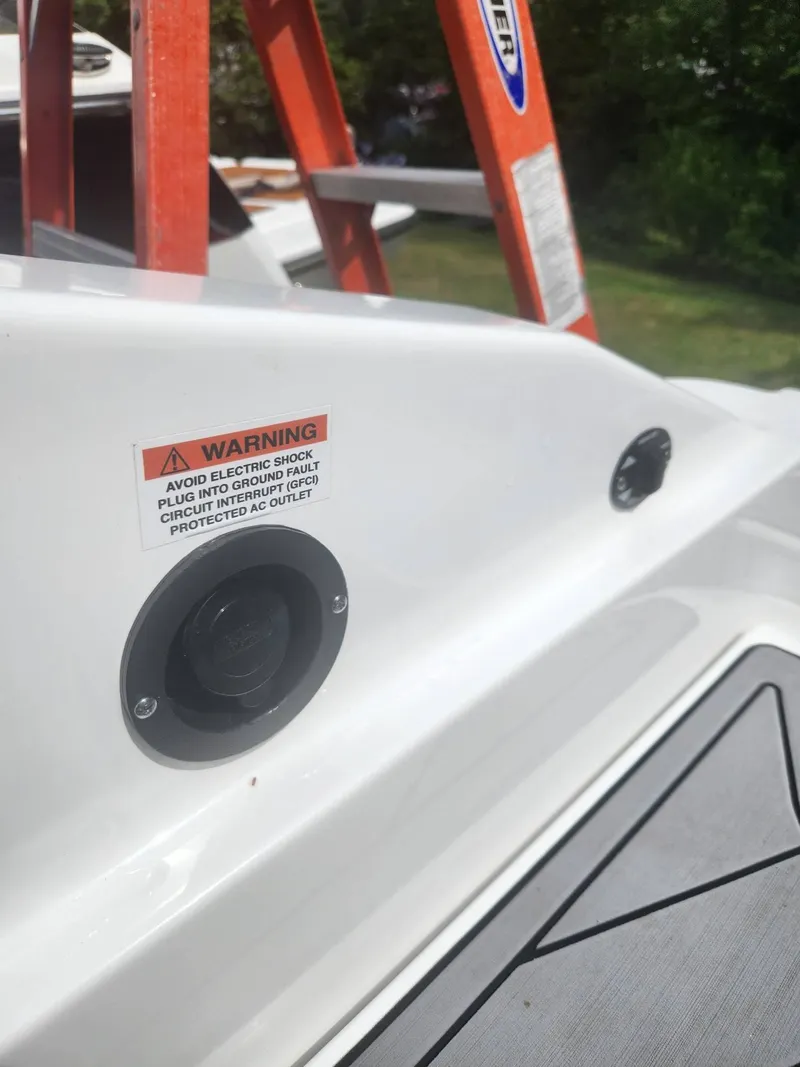 Slide: The Image of 2022 Monterey 278SS boat with warning label and electrical outlet. - 22