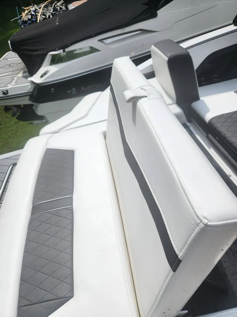 Slide: The Image of 2022 Monterey 278SS boat with white and gray seating, docked. - 24