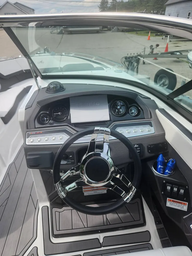 Slide: The Image of 2022 Monterey 278SS boat dashboard with steering wheel and control panel. - 8