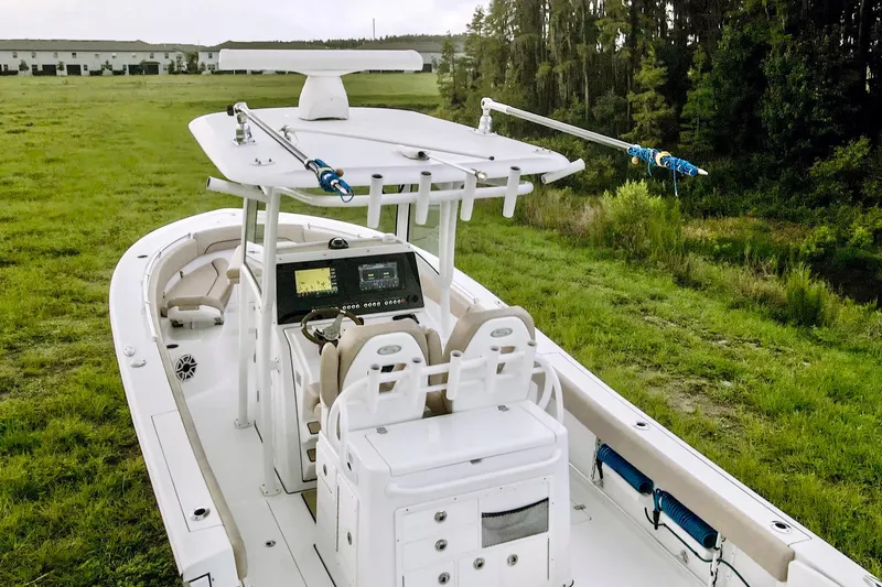 Slide: The Image of 2019 Sportsman Open 282 Center Console boat on grassy field. - 10