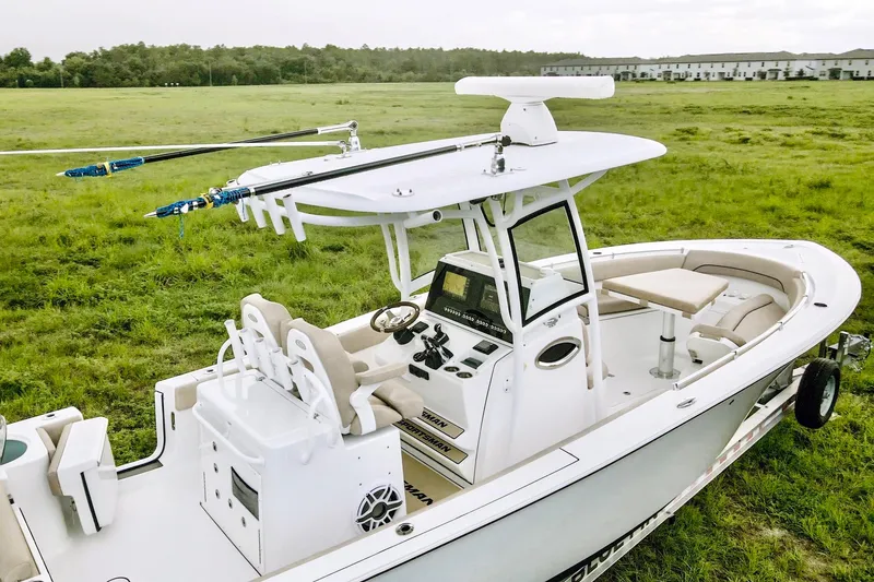 Slide: The Image of 2019 Sportsman Open 282 Center Console boat in a grassy field. - 11